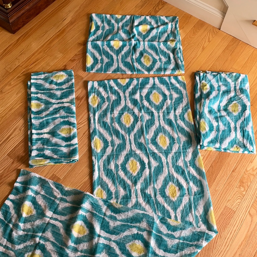 4 curtain panels. Teal, white, and yellow.